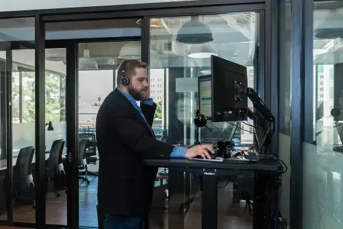 AllSafe IT expert working on a desktop computer in a modern office