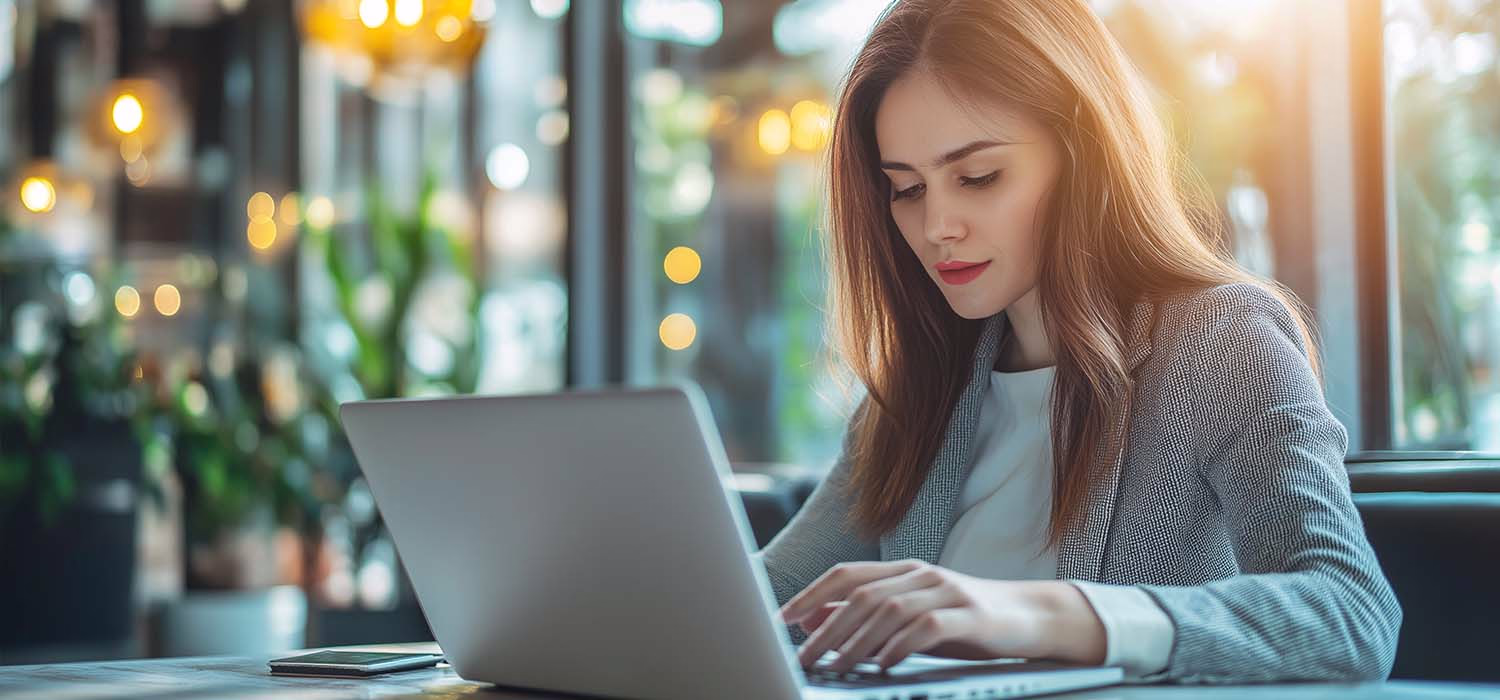 Business owner reviewing IT audit checklist on a laptop.