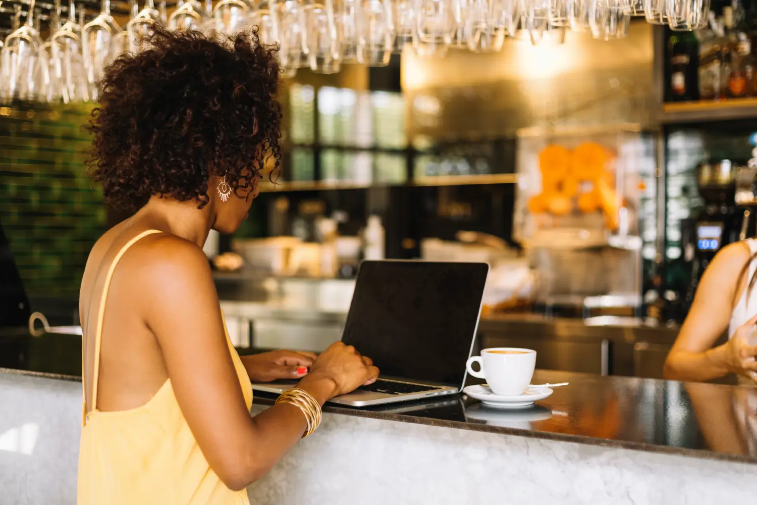 An Hospitality expert working on laptop placed on a counter top