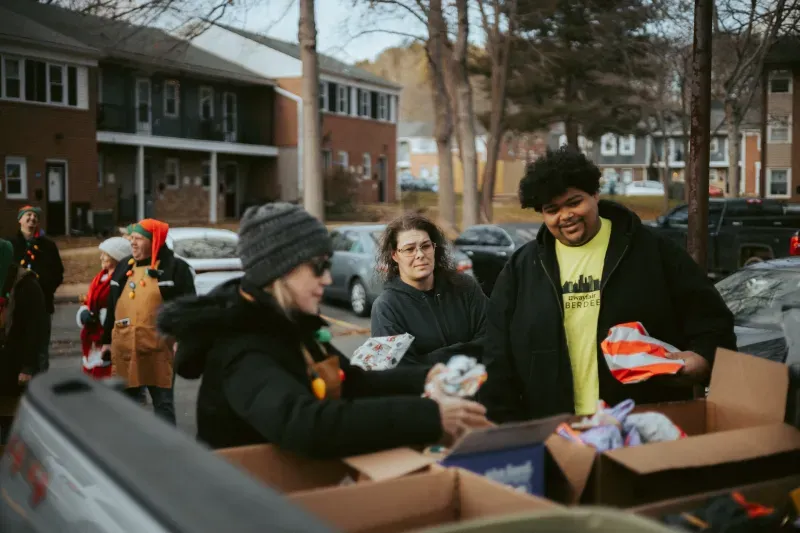Picture showing an NGO sharing clothes in a neighborhood